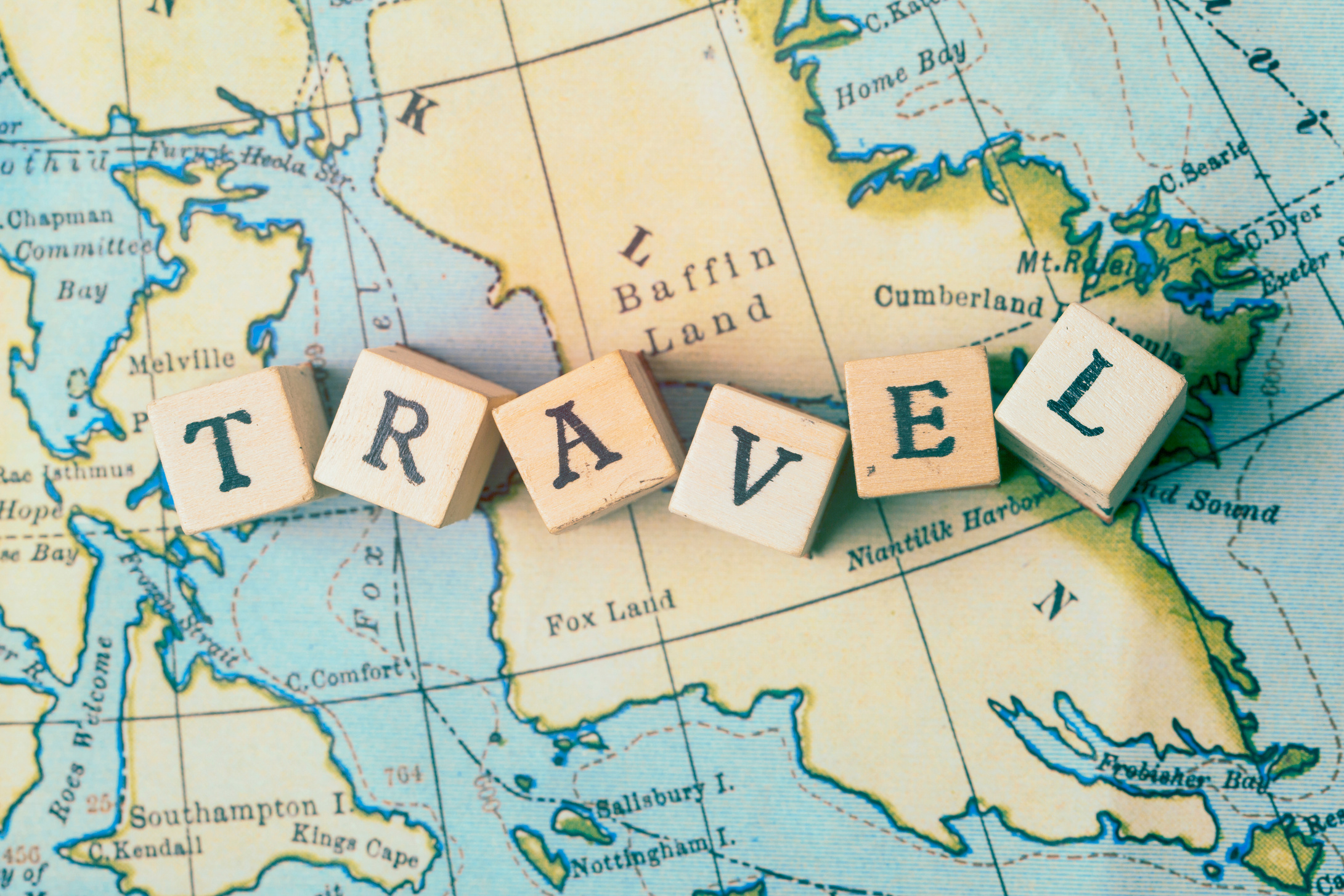 Travel Word in Wooden Blocks on Vintage Travel Map